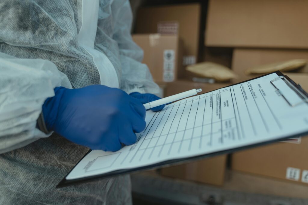 this image shows health and safety person wearing blue gloves checking for Aflatoxin in peanut butter